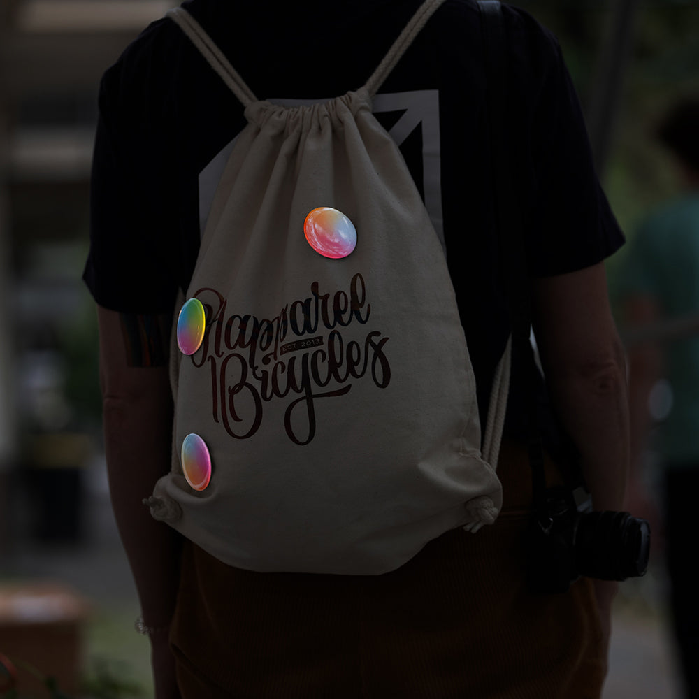 woman wearing gym-sack with a strap camera