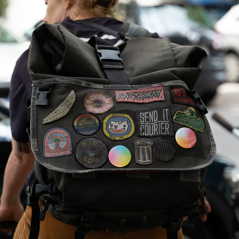 Courier woman riding bicycle with backpack