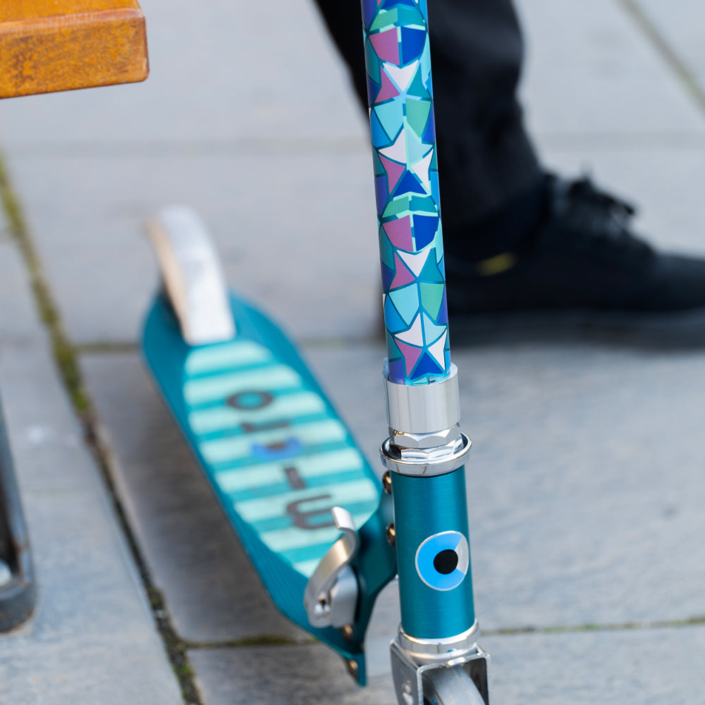 detail of scooter with reflective stickers and blurry background