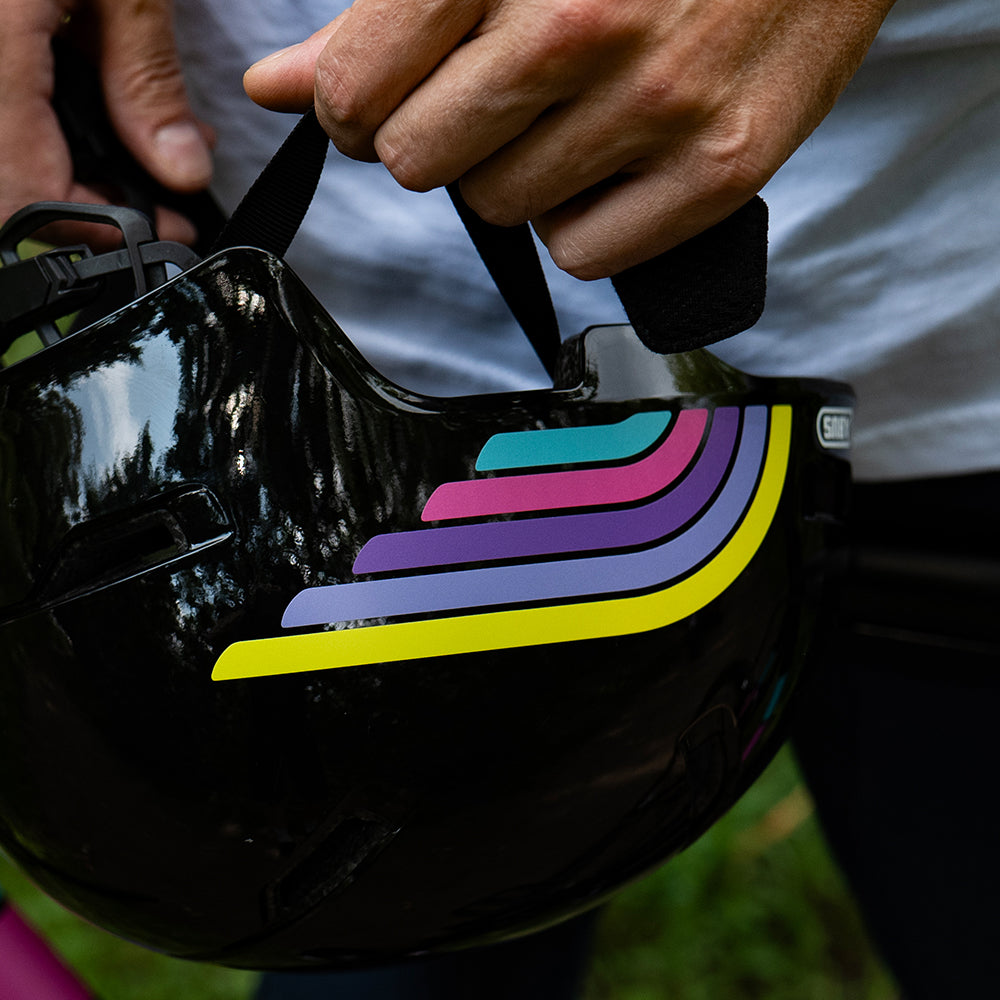 Reflective stickers on helmet with hands holding the strap