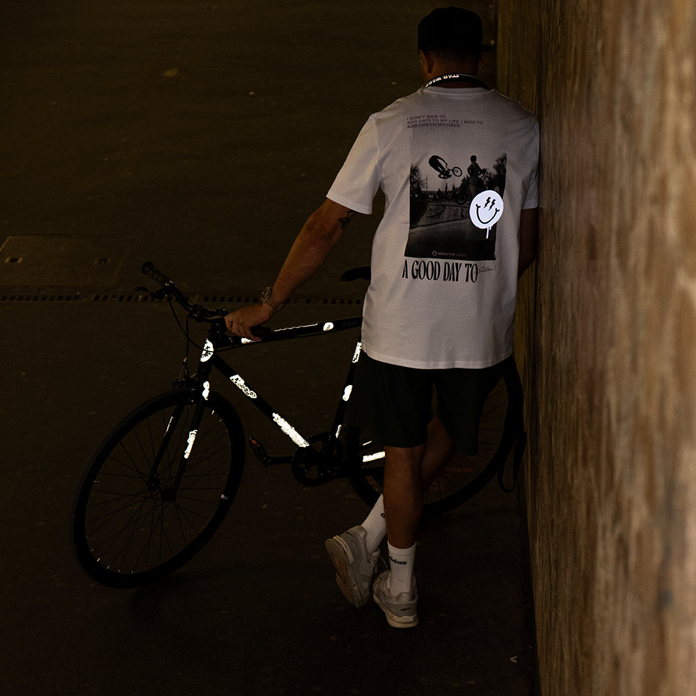 Man standing in underground tunnel holding bicycle with reflective sticker set