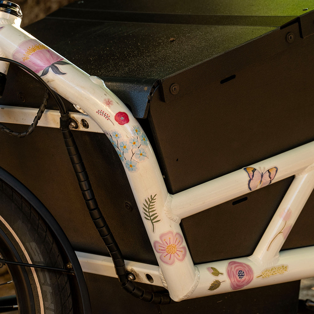Reflective flowers on white bicycle frame