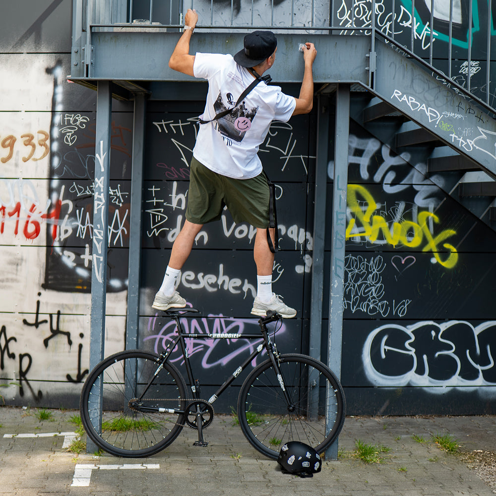 Artist MrP balancing on bicycle with reflective sticker set