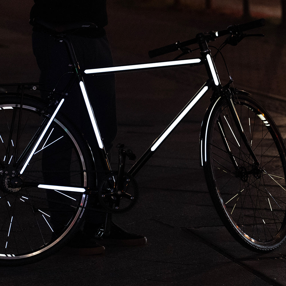 Bicycle with dark city background and reflective stickers stripes