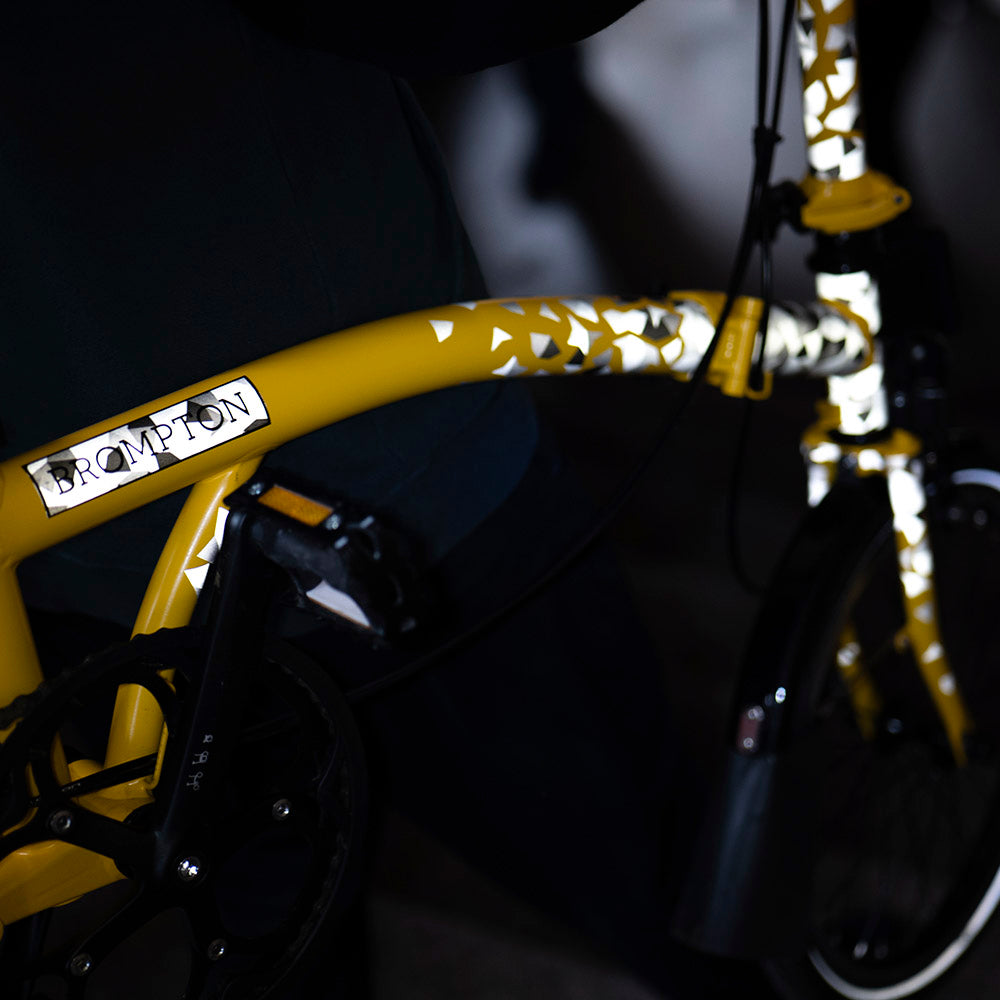 detail of bicycle with reflection in metro entrance