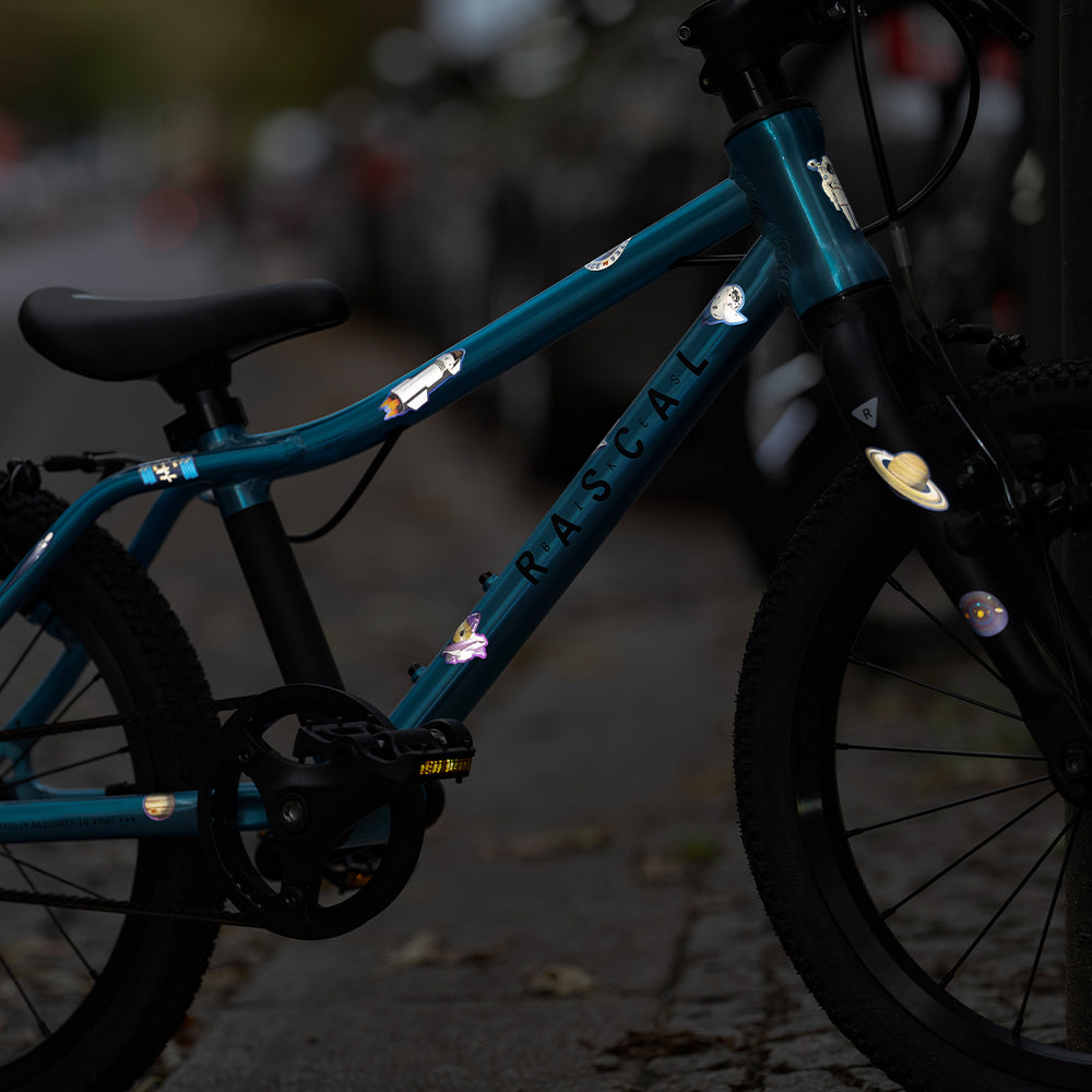 blue bicycle with reflective stickers and street in background