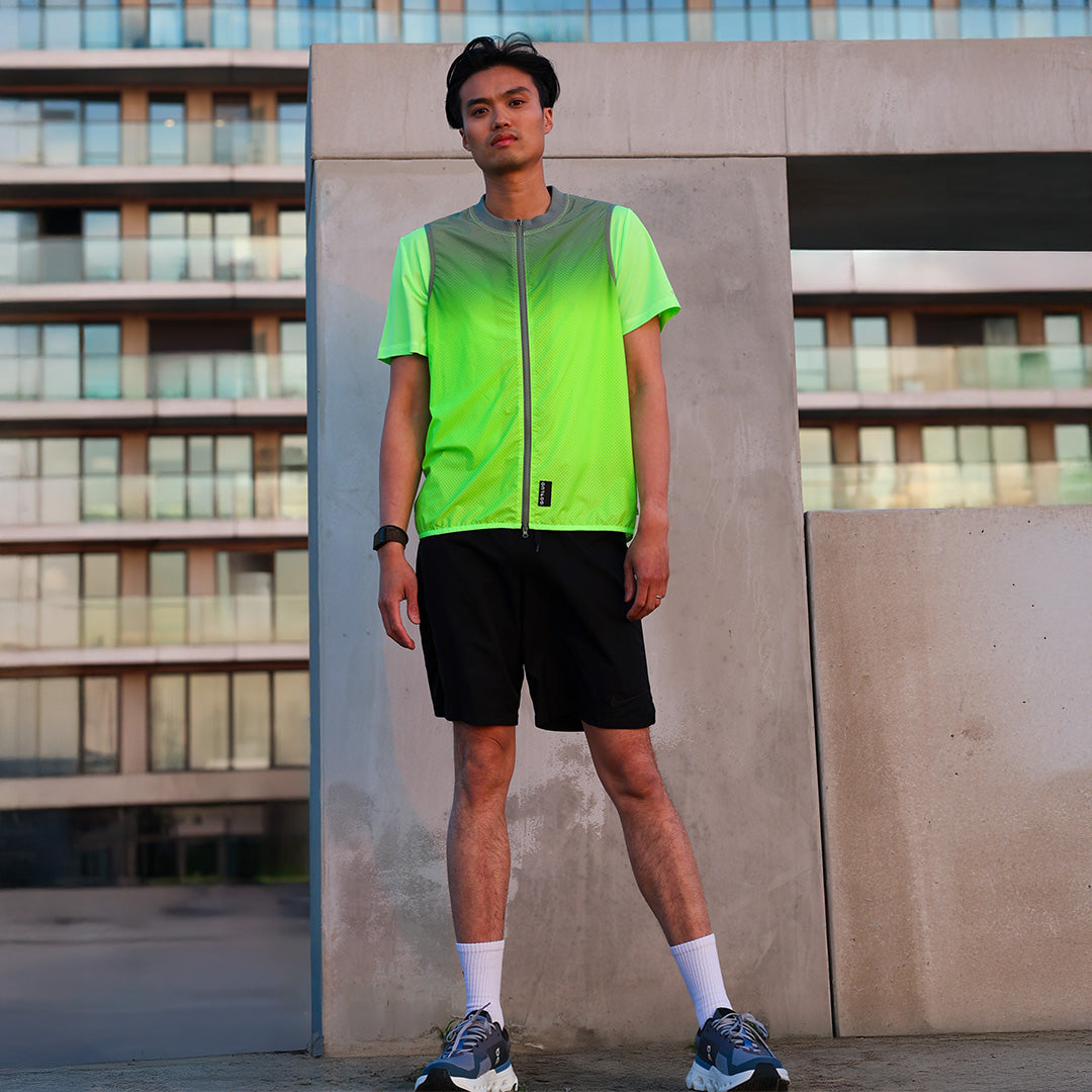 Man wearing reflective jacket with sport outfit in urban background