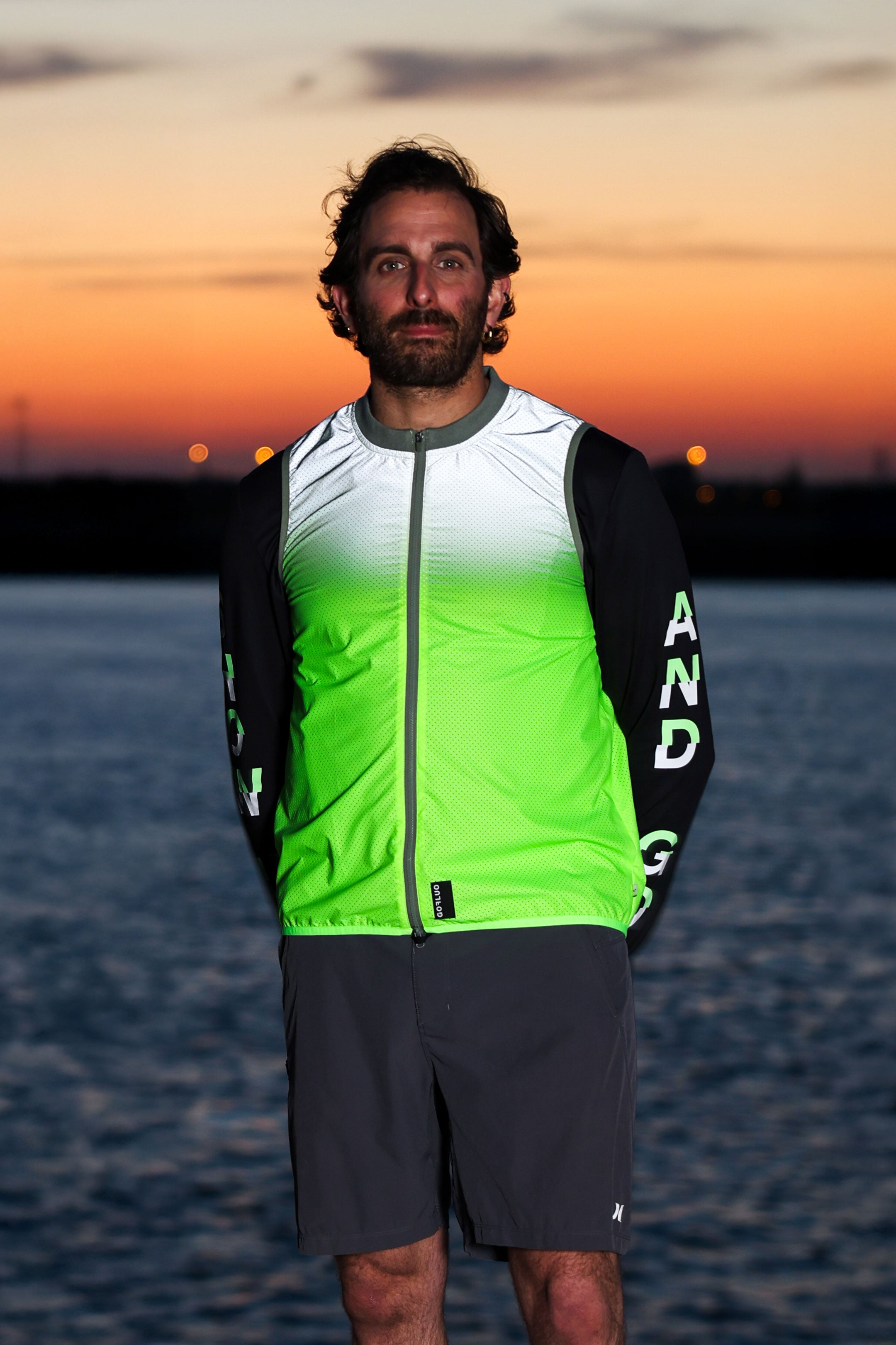 Runner wearing reflective vest with sunset background