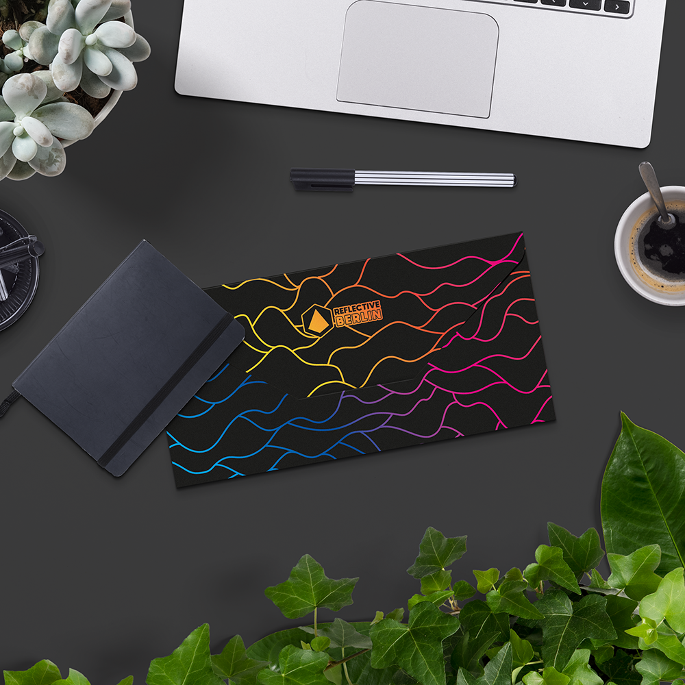 Closed giftcard, on desktop with computer and plants