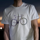 Rainbow bicycle design on t-shirt with man and sunset sky