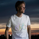rainbow reflective t-shirt design on man at night with sunset sky