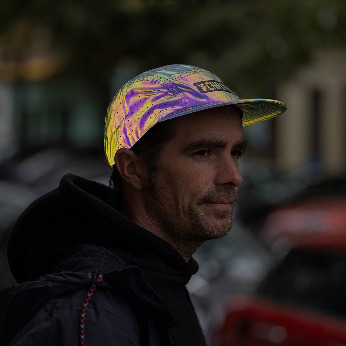 man wearing a reflective 5 panel cap