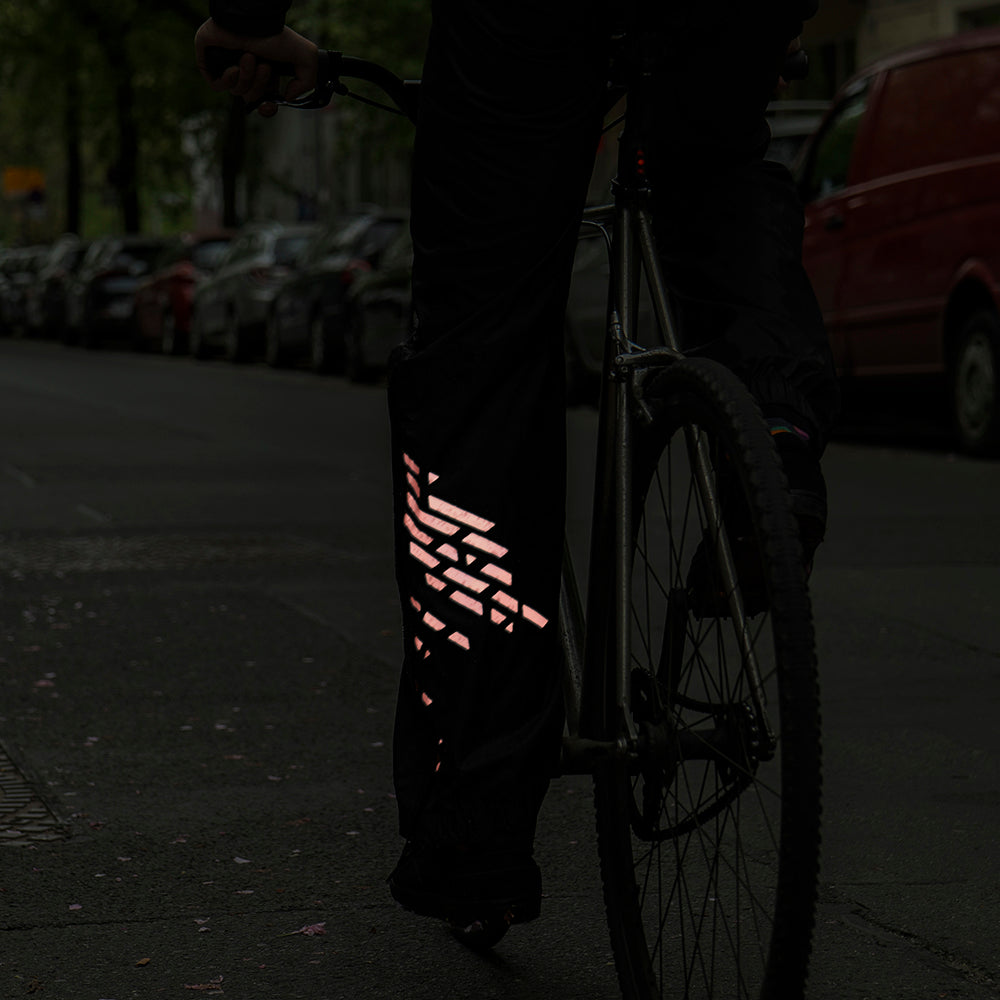 reflective stickers on rain pants, in empty street