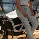 Woman sitting on cargo bike with flower design