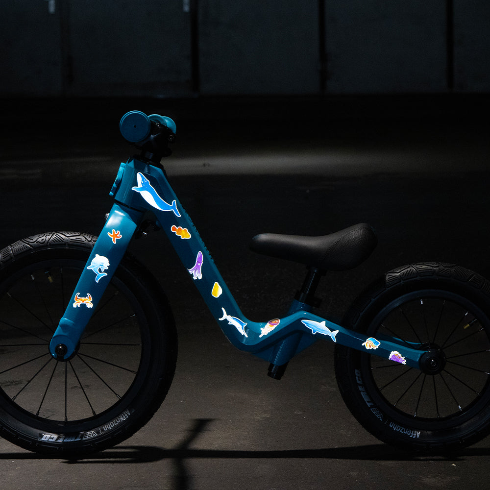 Kids bike with reflective aqua theme set and dark background