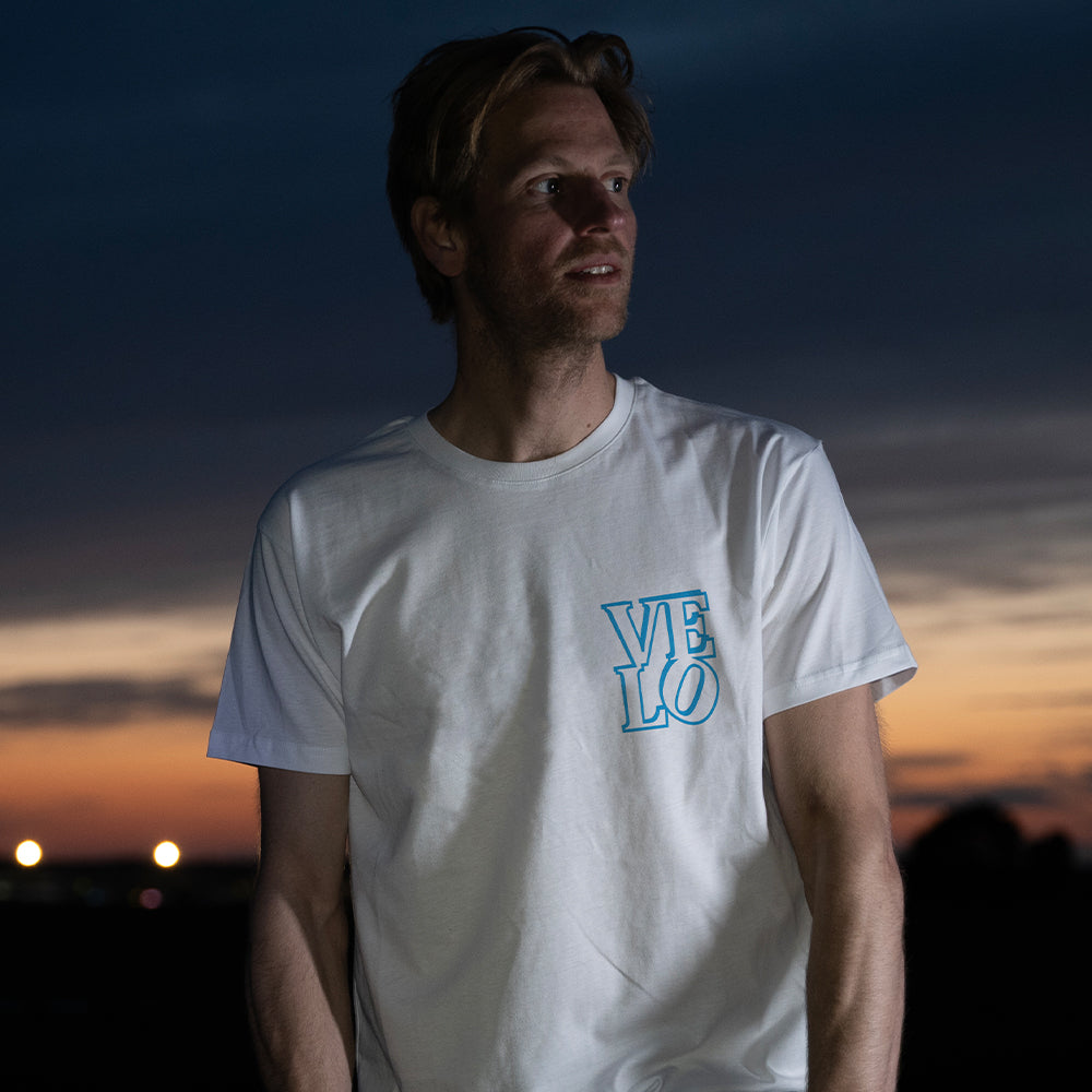 ma wearing reflective t-shirt ith elo logo and sunset background