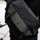 Close up of backpack with man and blurry background