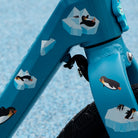 Close up of reflective penguin sticker set on kids bike with blue background