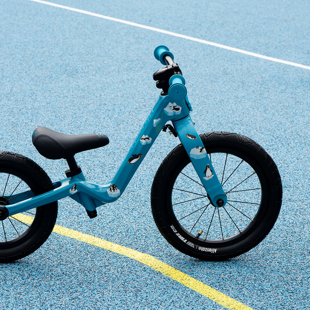 Kids bike with reflective penguin stickers and blue Background