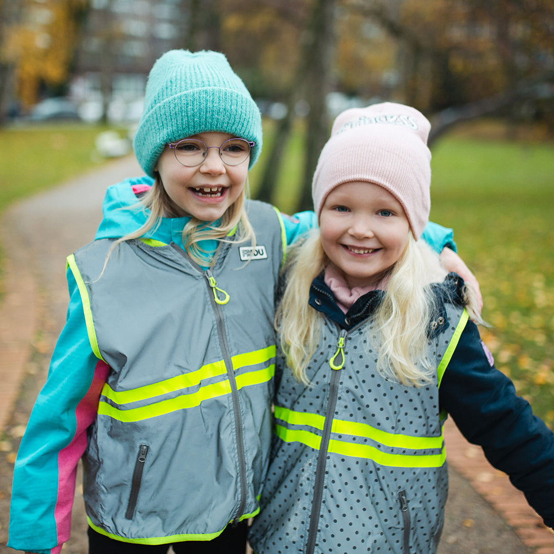 2 kids wearing visibility vest, laughing