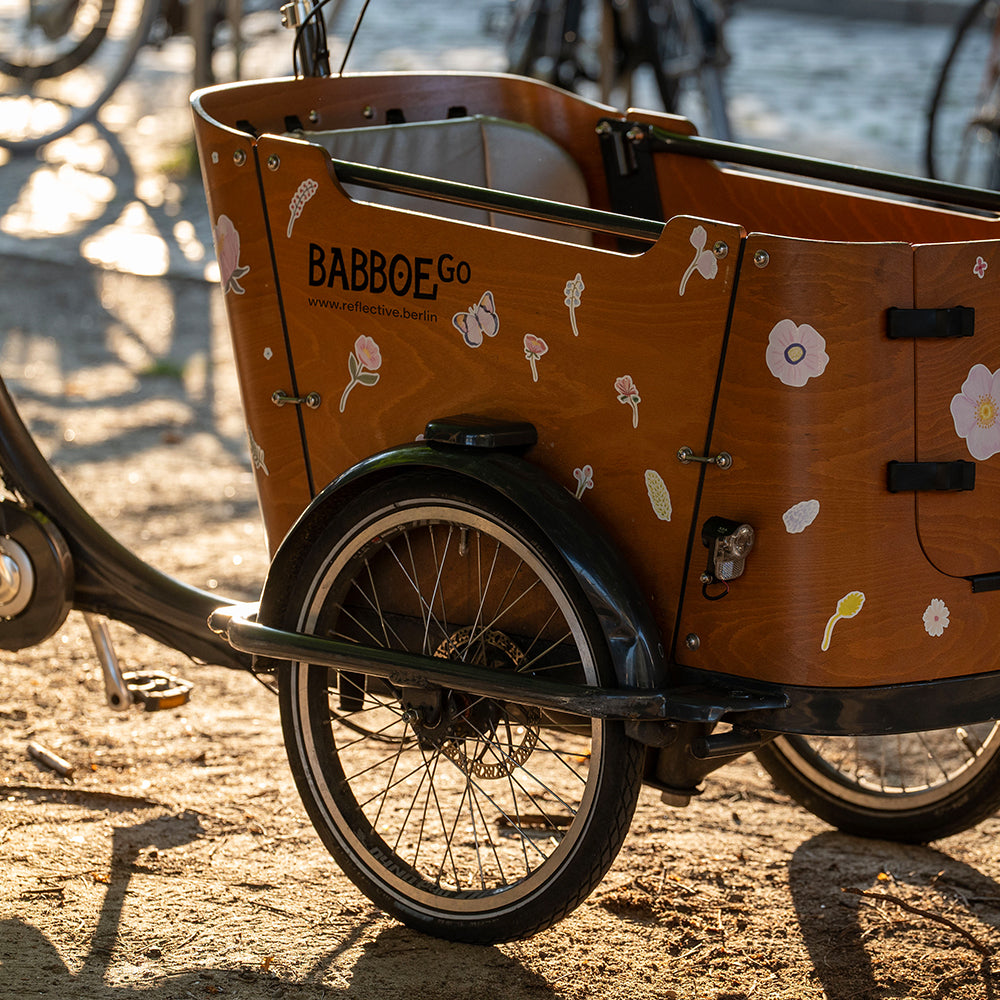 Reflective flower design on wooden cargo bicycle box
