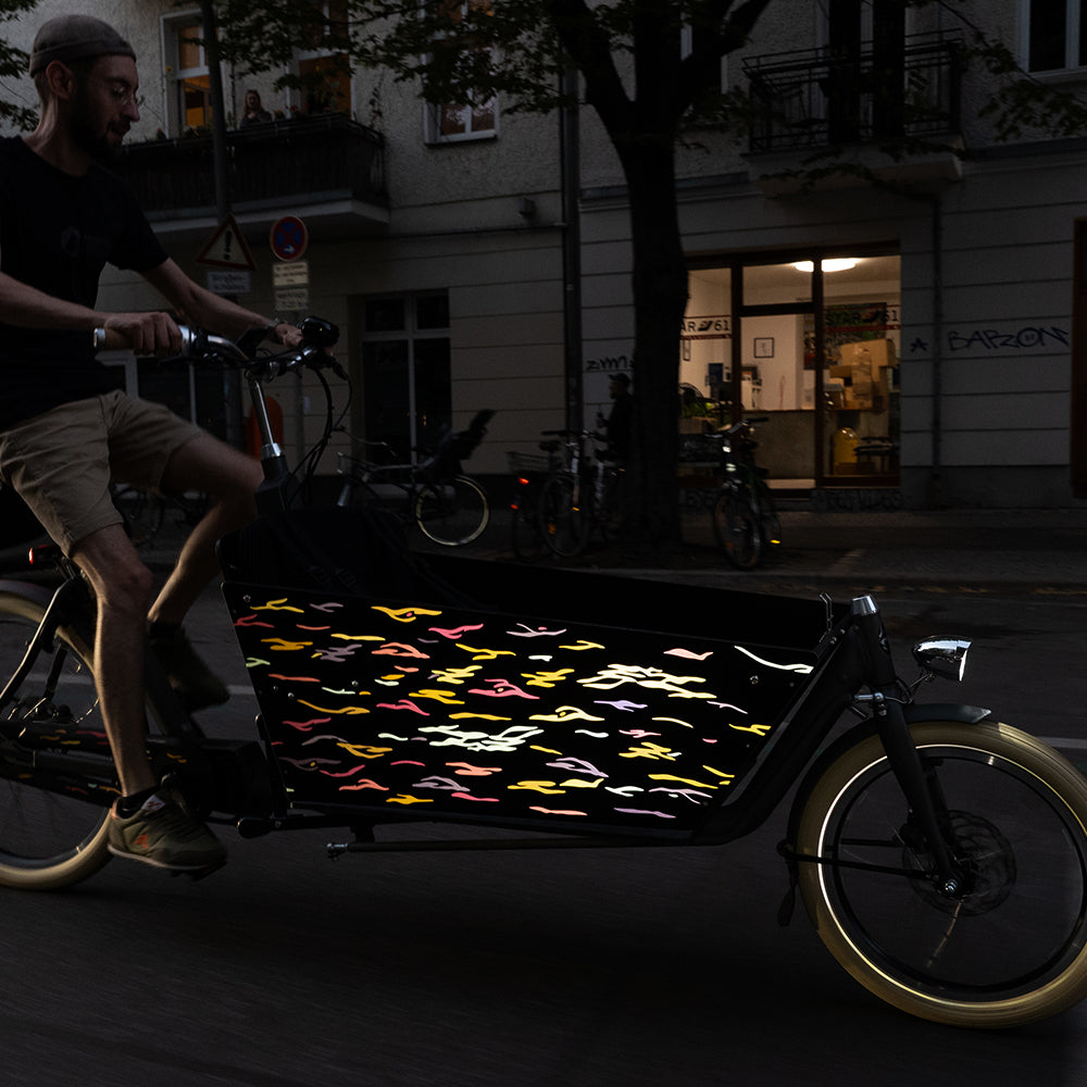 Reflective design applied on bicycle box at night riding in the night with blurry background