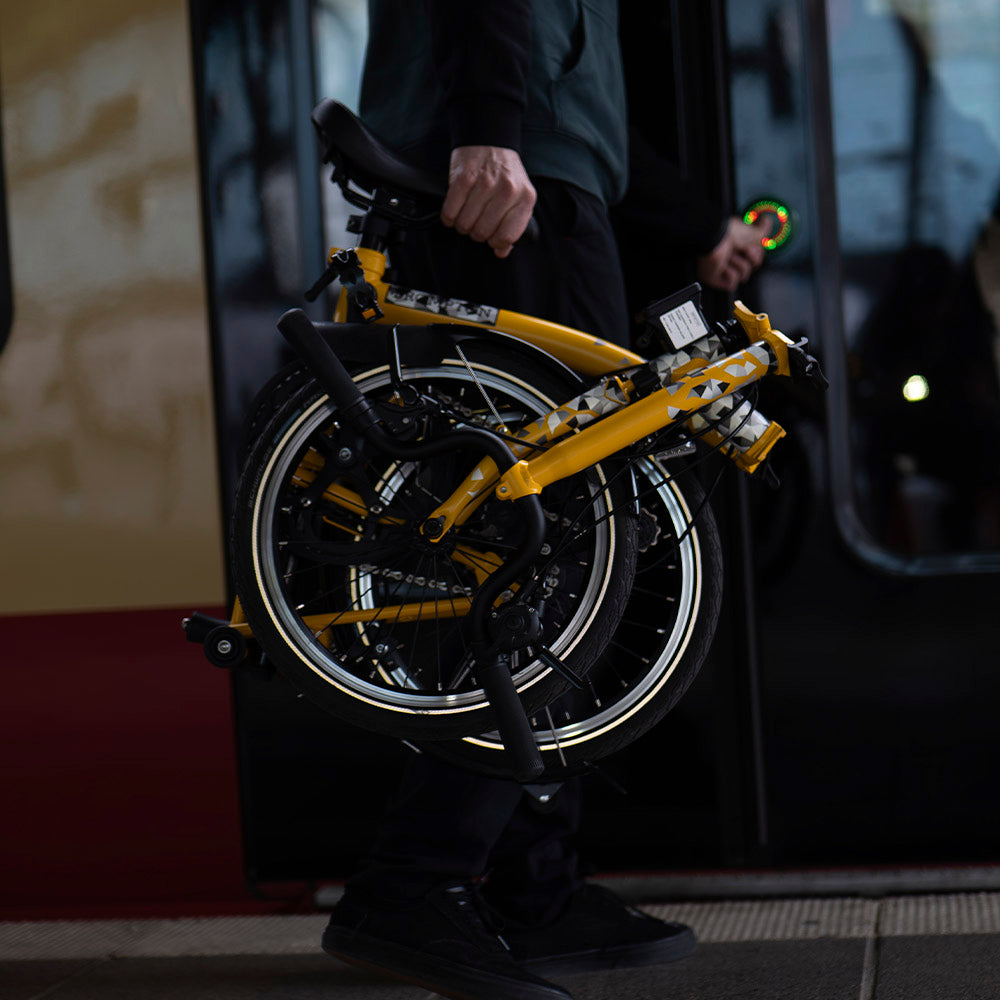 man entering metro with folding bicycle