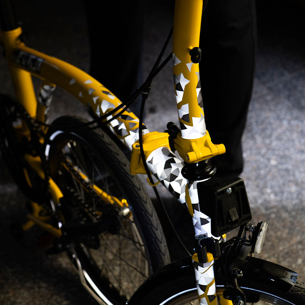 front of folding bicycle with reflective stickers and floor background