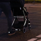 Reflective stripes applied on baby stroller, crossing the road