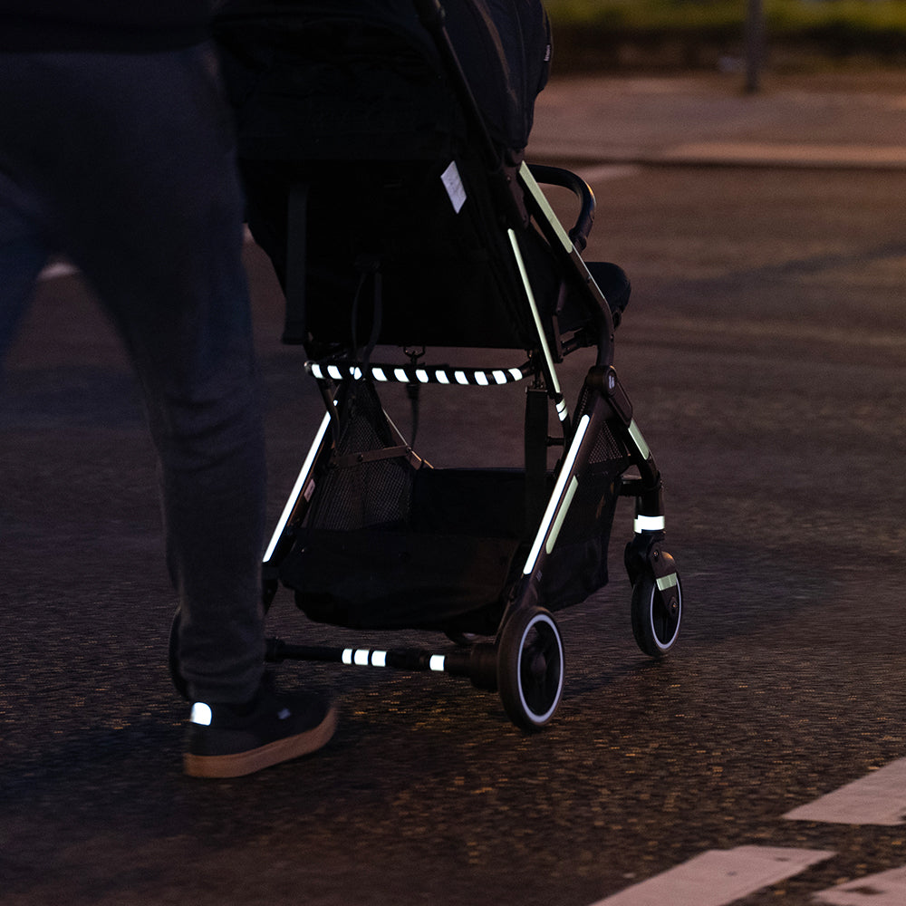 Reflective stripes applied on baby stroller, crossing the road