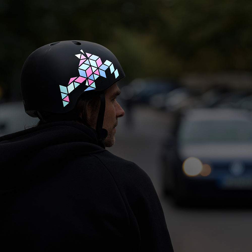 man wearing helmet in front of car