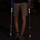 Reflective chevrons design applied on crutches , at night with man