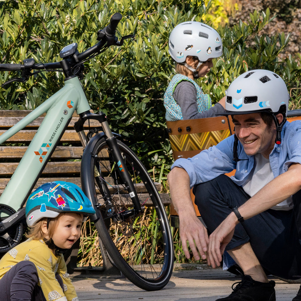 a family with bikes in a garden, showing reflective stickers application
