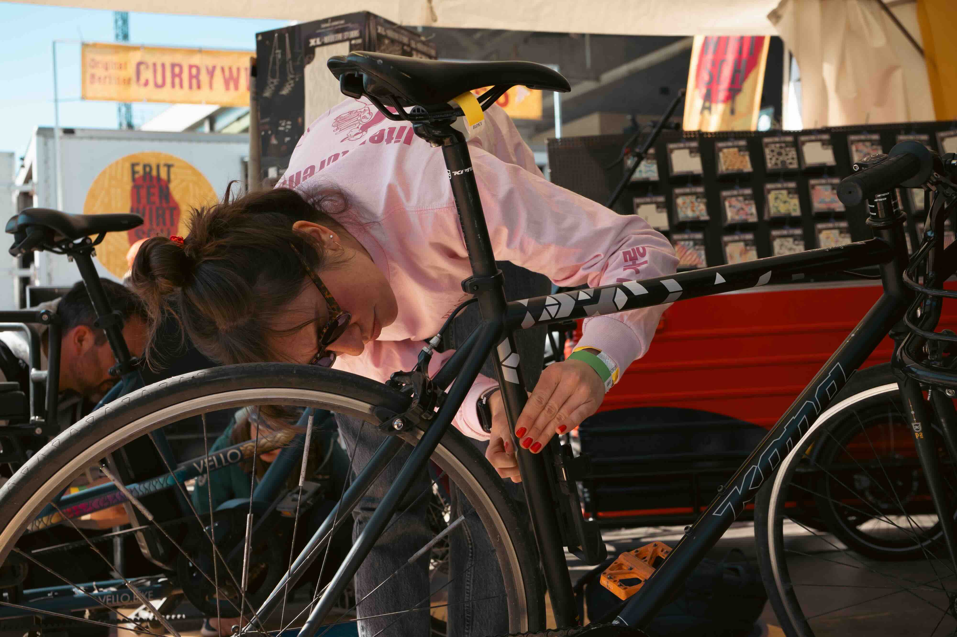 Kona Singlespeed Bike with grey reflective geometric stickers put on by a woman