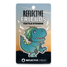 Reflektierender Aufkleber Textil Stoff „Lino“, ein T-Rex Dinosaurier mit Fahrradhelm und Knieschonern aus der Produktserie „Reflective Friends“ in Produktverpackung von REFLECTIVE Berlin.