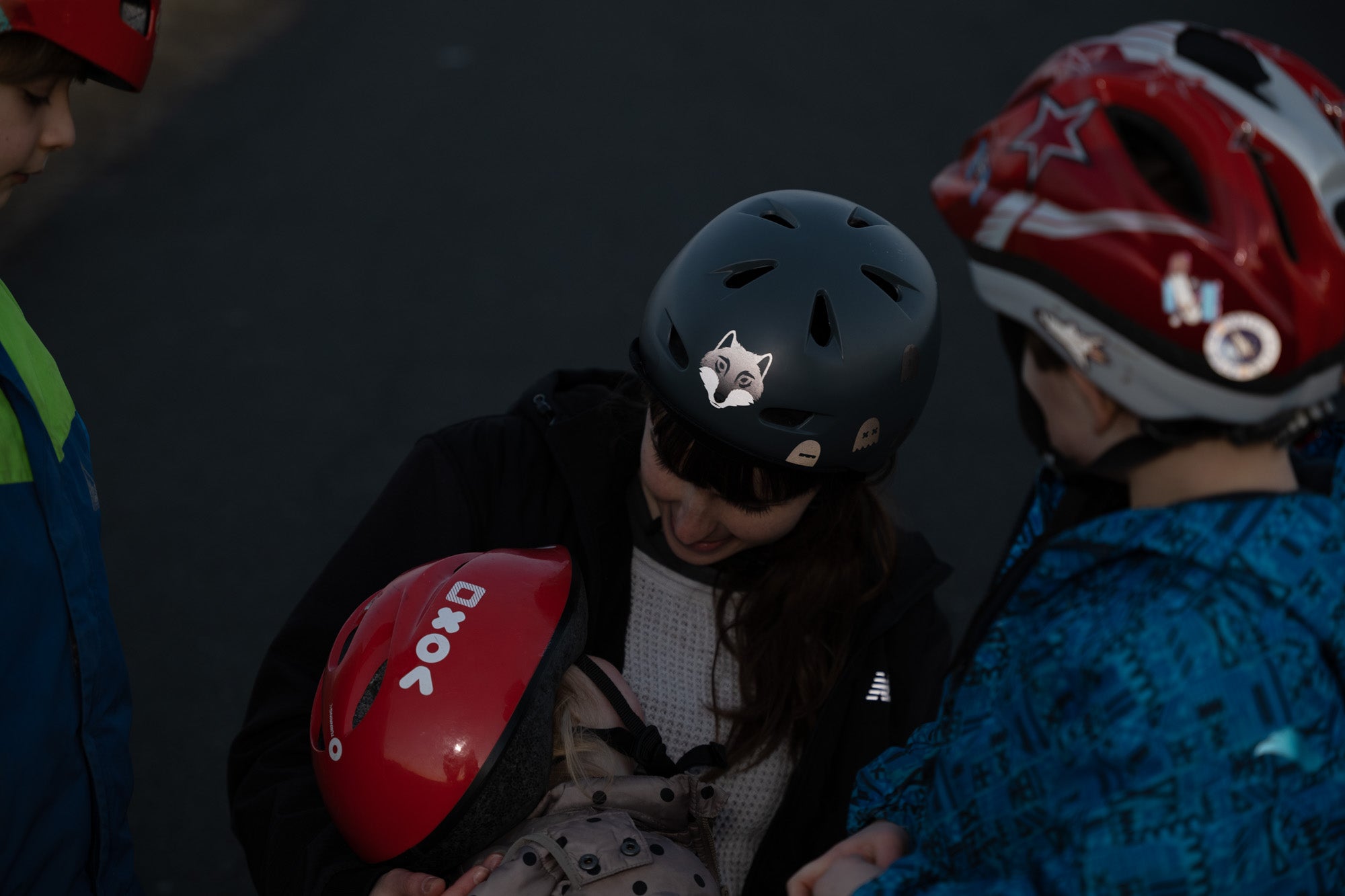 Wolf Weiß von REFLECTIVE Berlin auf Helmen von Familie mit Kindern mit stark reflektierendem Wolfsmotiv für mehr Sichtbarkeit im urbanen Stil.