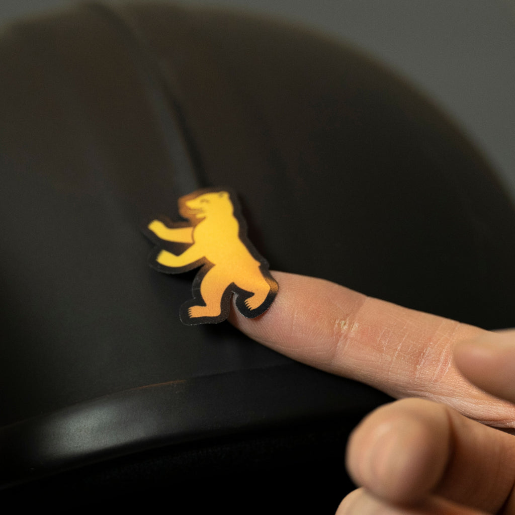 Gold Berlin bear sticking on helmet, hand application