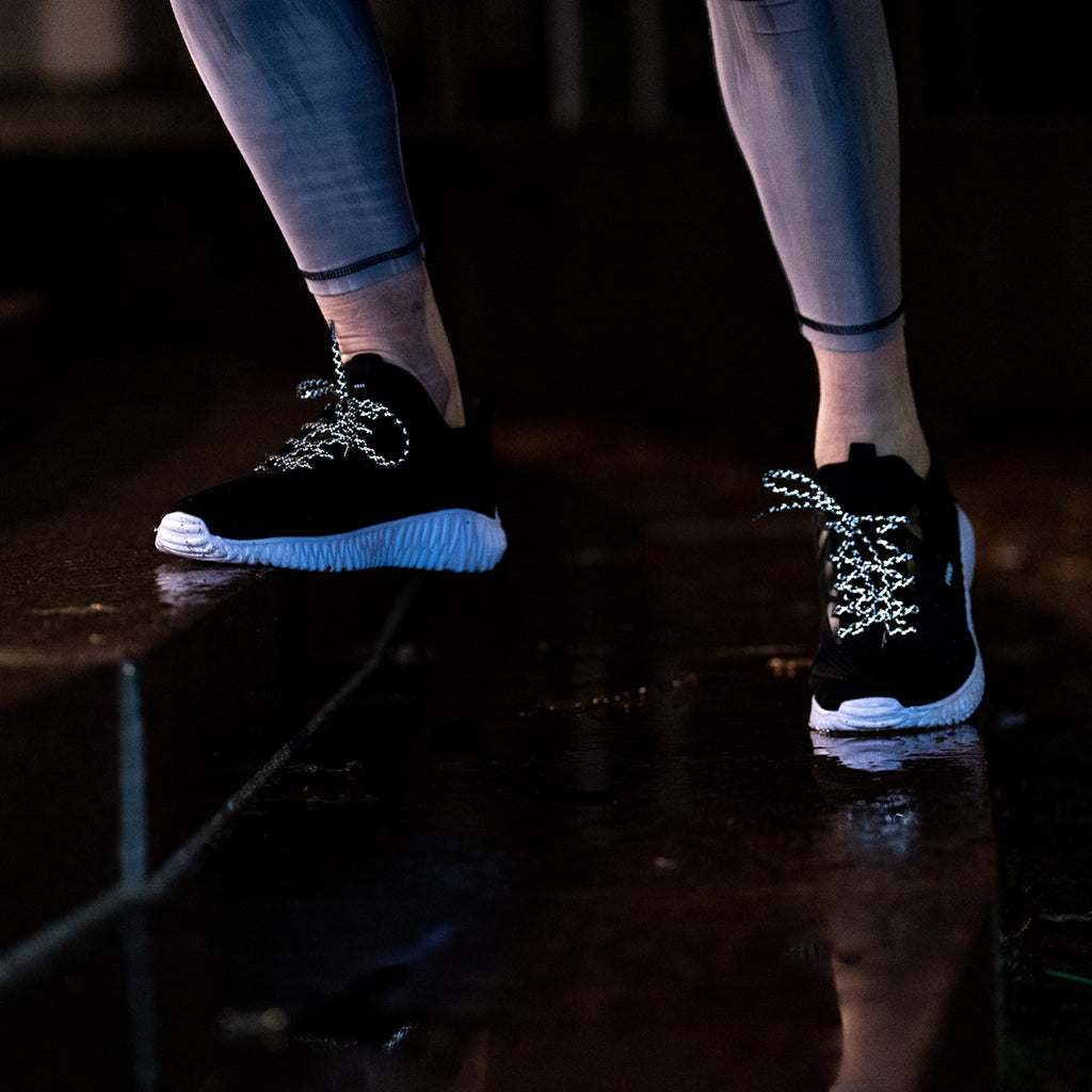 Reflective laces on shoes, going up the stairs